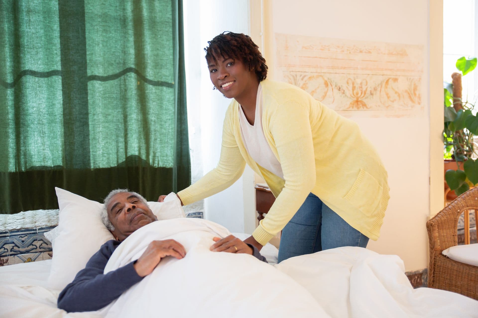 Caregiver warmly attending to a senior client at home
