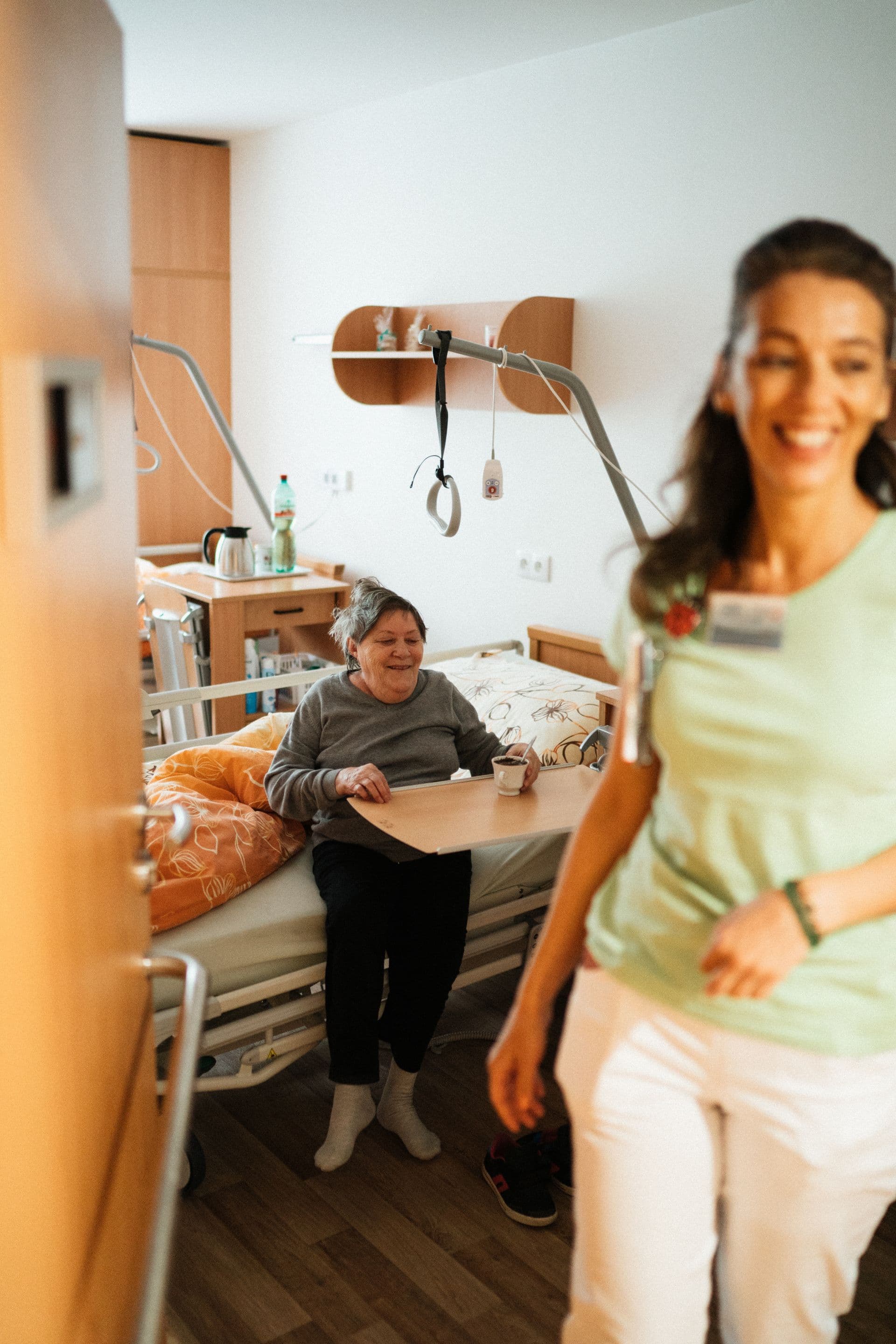Nurse warmly greeting a senior patient